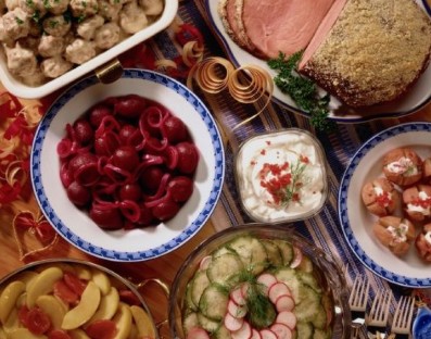 Different plates of food including beets, fruit, and shrimp