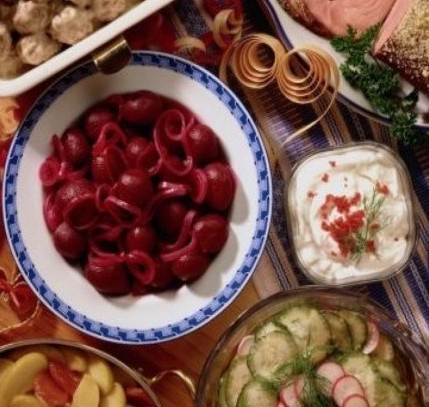 Different plates of food including beets, fruit, and shrimp